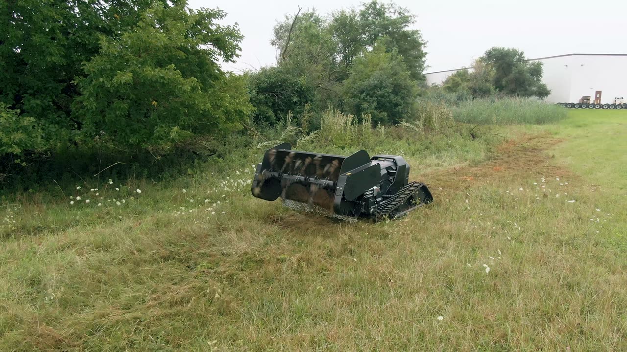 Video: tracked carrier sweeping a lane with a chain flail head.